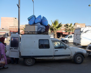 An overloaded minivan vehicle transporting goods in a Moroccan market in Casablanca or Marrakech Marrakesh