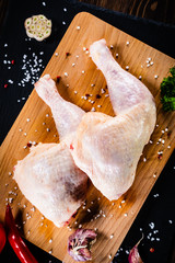 Raw chicken legs on wooden background © Jacek Chabraszewski