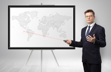 Handsome businessman with laser pointer presenting potential business area on map
