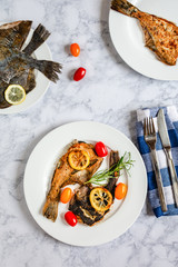 Grilled flounder fish served on white plate