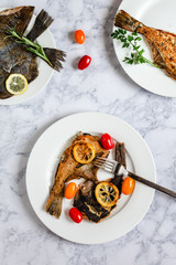 Grilled flounder fish served on white plate