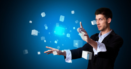 Man touching hologram screen displaying cube symbols