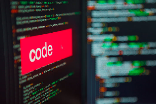 Programming and development, the inscription on the background of computer code.