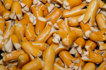 Pork sausage fried in oil as food background.