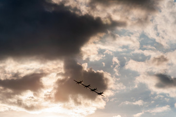 Aerobatics planes flying in the sky with clouds in the background