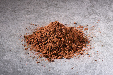 Cacao powder on gray concrete texture