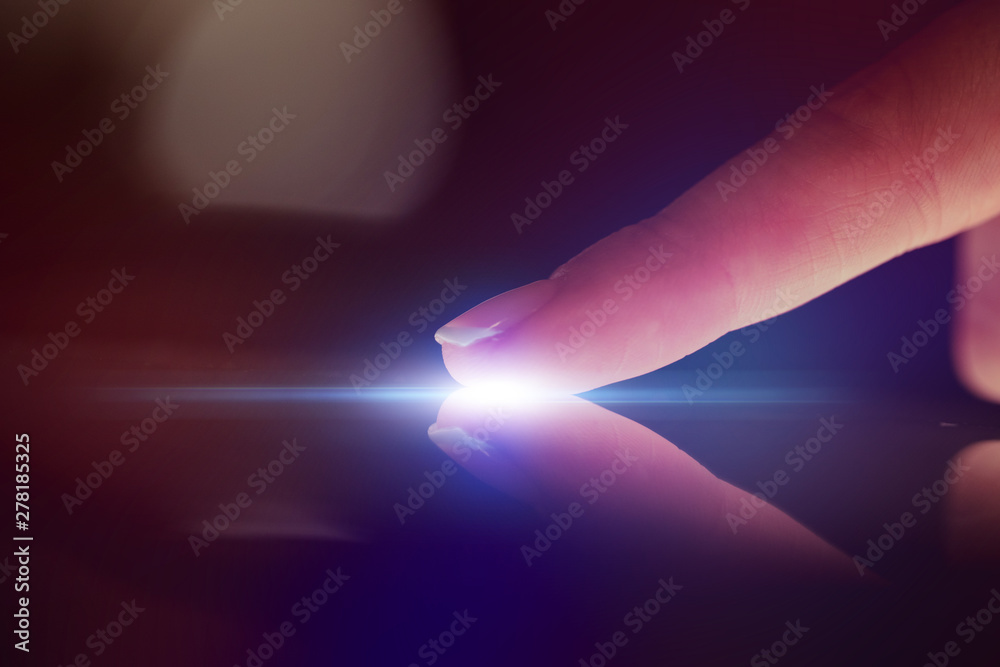 Poster finger touching tablet with dark background with copyspace