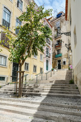 Fototapeta na wymiar Traditional street with staircase in Alfama district