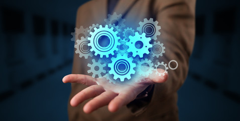 Hand holding gears in his hand