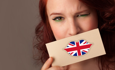 Person holding UK flag lips shape card