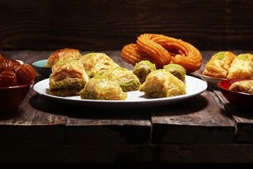 Middle eastern or arabic dishes. Turkish Dessert Baklava with pistachio on dishes