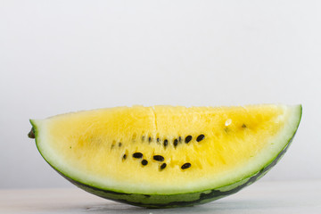 slice of yellow watermelon on a white background