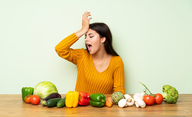 Fototapeta premium Teenager girl with many vegetables has realized something and intending the solution