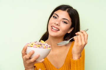 Happy Teenager girl having breakfast with bowl of cereals