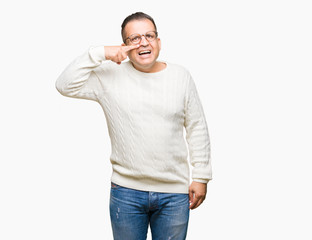 Fototapeta premium Middle age arab man wearing glasses over isolated background Pointing with hand finger to face and nose, smiling cheerful