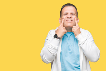 Middle age arab man wearing sweatshirt over isolated background Smiling with open mouth, fingers pointing and forcing cheerful smile