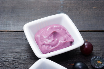 cosmetic cream from red grapes on black wooden
