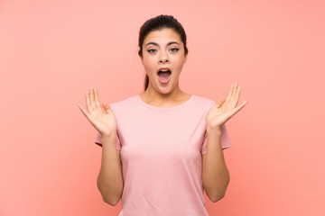 Teenager girl over isolated pink background with surprise facial expression