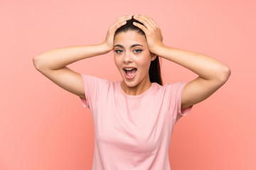 Teenager girl over isolated pink background with surprise facial expression