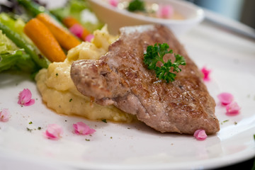 Pork grill steak set has baked potato with butter