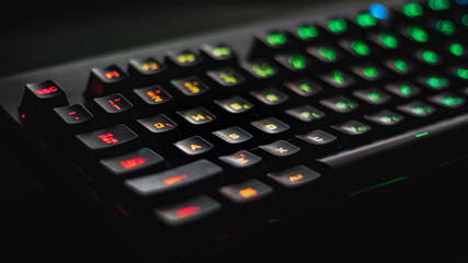 Obraz premium Blurred illuminated multicolor gaming keyboard