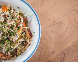 Delicious caesar salad and goatcheese salad on wooden table