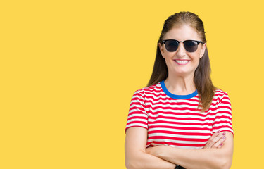 Middle age mature woman wearing sunglasses over isolated background happy face smiling with crossed arms looking at the camera. Positive person.