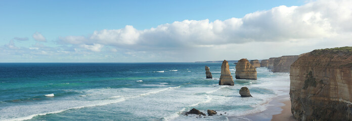 panoramic views of wild winter waves crashing against iconic Australian sandstone rock formations,...