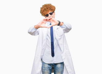 Young handsome scientist man wearing professional coat and sunglasses smiling in love showing heart symbol and shape with hands. Romantic concept.