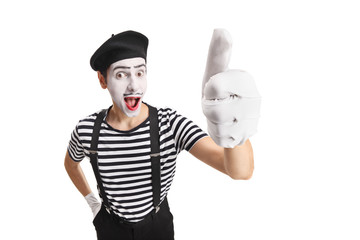 Cheerful young pantomime man showing thumbs up - obrazy, fototapety, plakaty