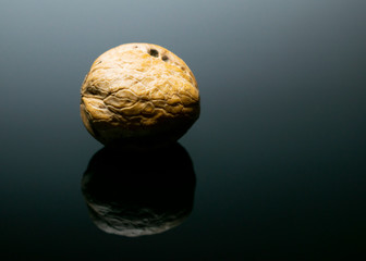 Delicious walnuts and hazelnuts on a mirrored podium with minimal light.