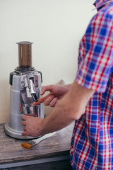 Portrait of a smiling barista preparing a coffee at the coffee shop