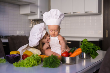  little girl and boy, white chef hat, vegetables