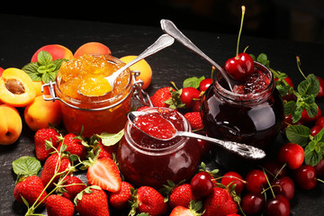 assortment of jams, seasonal berries, apricot, mint and fruits. marmalade or confiture