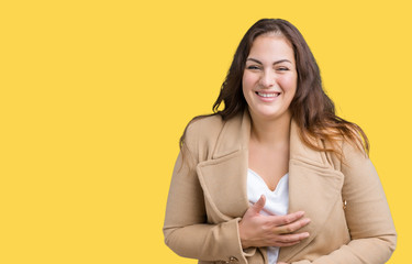 Beautiful plus size young woman wearing winter coat over isolated background Smiling and laughing hard out loud because funny crazy joke. Happy expression.