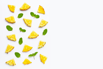 Fresh pineapple with mint leaves on white