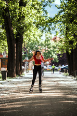 Fototapeta premium Girl rollerblading with headphones active lifestyle on inline skates