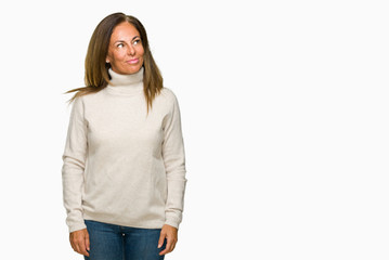 Beautiful middle age adult woman wearing winter sweater over isolated background smiling looking side and staring away thinking.