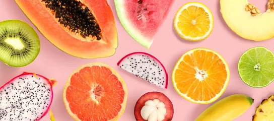 Tuinposter Creative layout made of papaya, grapefruit, lemon, kiwi, melon, watermelon, banana, pineapple, orange, mangosteen and flowers on pink background.  Tropical flat lay. Summer fruits concept.  © StudioDFlorez