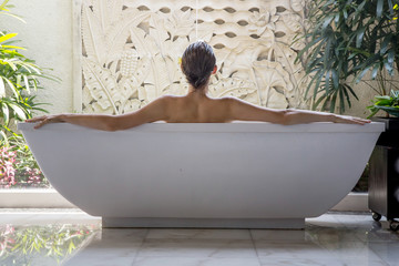 File name:Portrait of a young woman relaxing in the bathtub, organic skin-care at the luxury hotel...