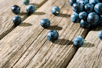 red grapes on old weathered wooden table
