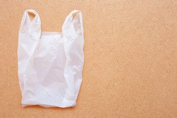 White plastic bag on wooden background.