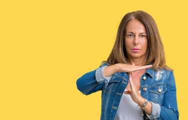Beautiful middle age woman wearing casual denim jacket over isolated background Doing time out...
