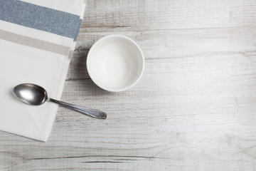 Empty clean bowl and spoon on the table,top view.Copy space