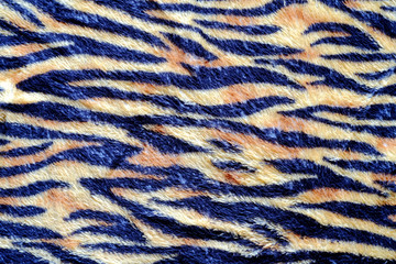 Black and yellow Tiger stripe on cloth background.