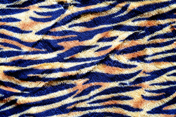 Black and yellow Tiger stripe on cloth background.