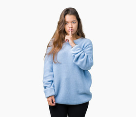 Young beautiful brunette woman wearing blue winter sweater over isolated background asking to be quiet with finger on lips. Silence and secret concept.