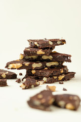 Homemade dark chocolate with walnut. Raw chocolate with nuts, kerob, stevia, acai, guarana. Selective focus, close up