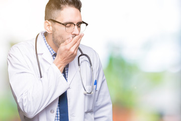 Handsome young doctor man over isolated background bored yawning tired covering mouth with hand. Restless and sleepiness.
