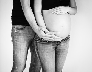 pregnant belly couple holding hands around baby bump